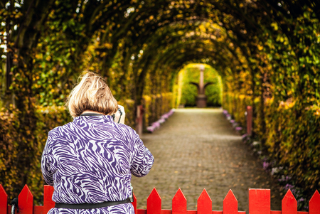 Old woman photographs park. Muiderslot castle ancient park ensemble in Muiden, Noord-Holland, The Netherlands.のeditorial素材