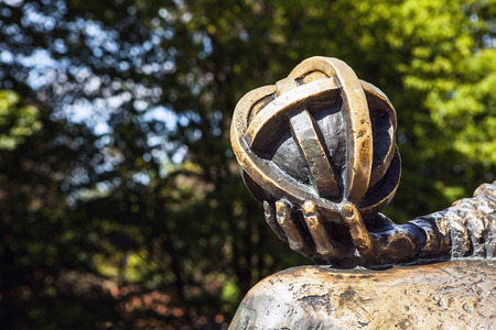 OLSZTYN - POLAND AUGUST 20, 2015: Planet in hand of Nicolaus Copernicus statue near his famous castle in Olsztyn, Polandのeditorial素材