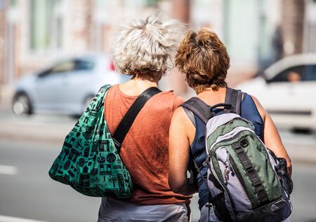 AMSTERDAM, NETHERLANDS - AUGUST 27, 2015: Two women expect transport on bus-stop. Amsterdam - Netherland.のeditorial素材