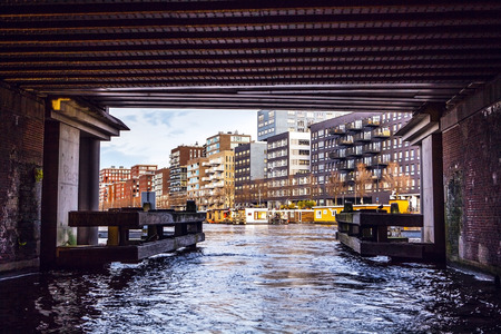 NETHERLANDS, AMSTERDAM - JANUARY 15, 2016: Bridge on river channel in January. Amsterdam -...