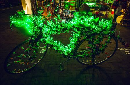 Bicycle with brightly green illumination & decorative elements at night time.の写真素材