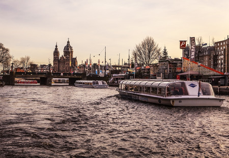AMSTERDAM, NETHERLANDS - JANUARY 30, 2015: Beautiful views of streets, ancient buildings, boat, embankments of Amsterdam - also call "Venice in the North". Amsterdam - Netherland.のeditorial素材