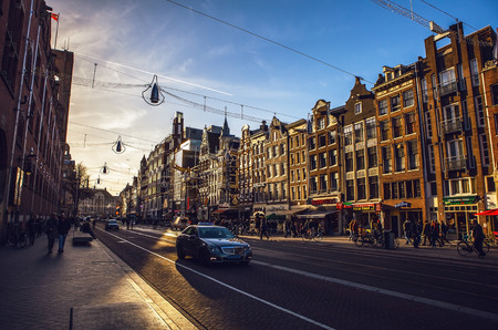 AMSTERDAM, NETHERLANDS - JANUARY 15, 2016: Famous buildings of Amsterdam city centre close-up at sun set time. General landscape view. Amsterdam - Netherlands.のeditorial素材