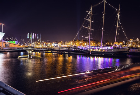 AMSTERDAM, NETHERLANDS - JANUARY 1, 2016:  General view on night canal in center of Amsterdam from bridge near museum Nemo. On January 1, 2016 in Amsterdam - Netherland.のeditorial素材