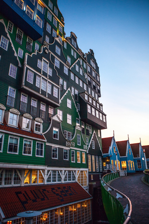 ZAANDAM, NETHERLANDS - MARCH 18, 2016: Inntel hotel at twilight time. Opened in 2009, design attracts guests by incorporating traditional architecture of Zaan region on 18 March in Zaandam, Holland.のeditorial素材