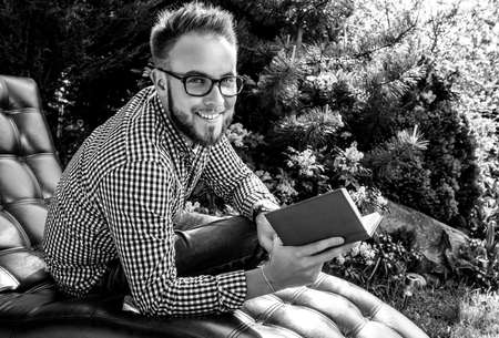 Black-white portrait of beautiful young man outdoor.