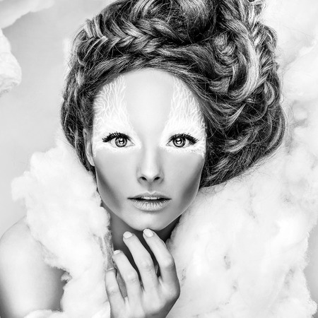 Romantic beauty with magnificent hair wandering in clouds. Fine art black-white studio fashion portrait.の写真素材