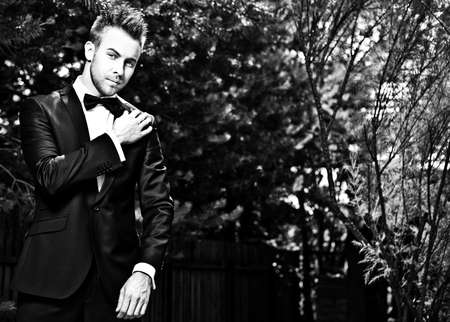 Black-white portrait of beautiful young man outdoor.の写真素材