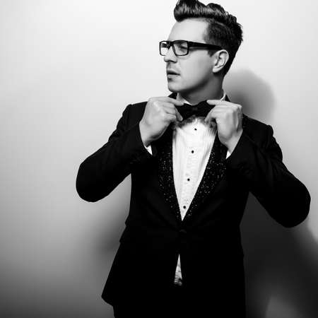 Elegant stylish handsome man. Black-white studio fashion portrait.の写真素材