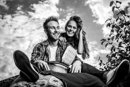 Positive young couple spending time outdoors. Black-white photo.の写真素材