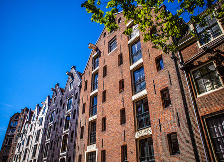 AMSTERDAM, NETHERLANDS - AUGUST 15, 2016: Famous buildings of Amsterdam city centre close-up....