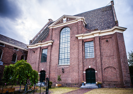 ZAANDAM, NETHERLANDS - JUNE 13, 2016: General landscape views in traditional church architecture of Zaan region at twilight on 13 June in Zaandam, Holland.のeditorial素材