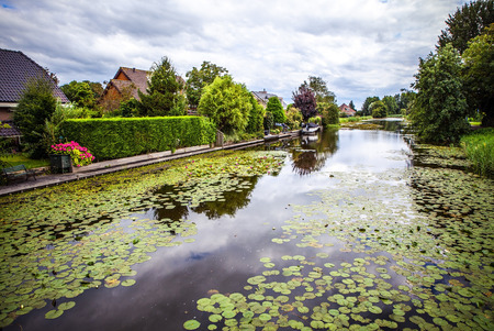 Beautiful traditional Dutch landscape, channels and buildings.