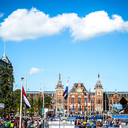 AMSTERDAM, NETHERLANDS - AUGUST 15, 2016: Famous buildings of Amsterdam city centre close-up. General landscape view of city streets and traditional Dutch architecture. Amsterdam - Netherlands.のeditorial素材