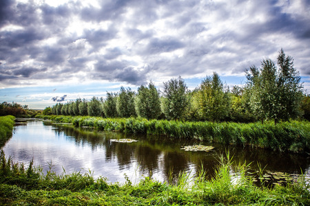 Beautiful traditional Dutch landscape, channels and buildings.