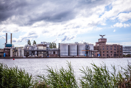 AMSTERDAM, NETHERLANDS - AUGUST 14, 2016: Famous Industrial buildings of Amsterdam city close-up. General landscape view of city building and traditional Dutch architecture. Amsterdam - Netherlands.のeditorial素材