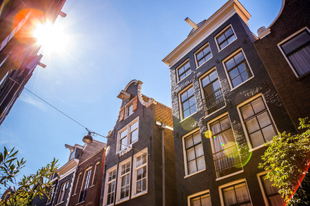 AMSTERDAM, NETHERLANDS - AUGUST 15, 2016: Famous buildings of Amsterdam city centre close-up....