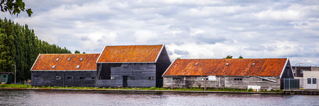 AMSTERDAM, NETHERLANDS - AUGUST 14, 2016: Famous Industrial buildings of Amsterdam city. General panoramic landscape view of city building and traditional Dutch architecture. Amsterdam - Netherlands.のeditorial素材