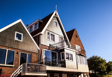 VOLENDAM, NETHERLANDS - JUNE 18, 2014: Traditional houses & streets in Holland town Volendam, Netherlands. Volendam - a small town that has preserved the tradition of Dutch fishing villages.のeditorial素材