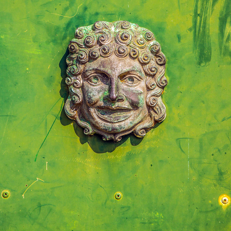 Ancient Venetian door with old door knob close-up.の写真素材