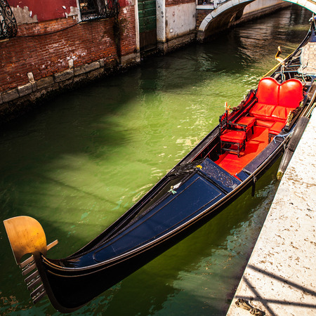 VENICE, ITALY - AUGUST 17, 2016: Traditional gondolas on narrow canal close-up on August 17, 2016 in Venice, Italy.のeditorial素材