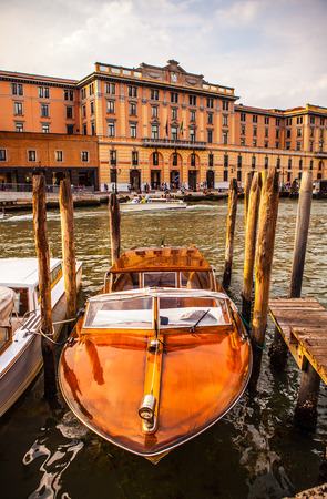 VENICE, ITALY - AUGUST 17, 2016: Retro brown taxi boat on water in Venice on August 17, 2016 in Venice, Italy.のeditorial素材