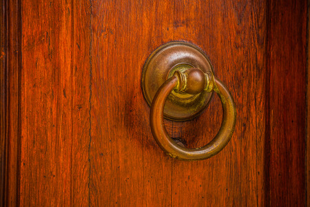 Ancient Venetian door with old door knob close-up.