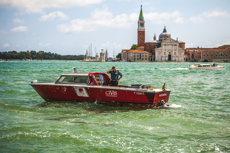 VENICE, ITALY - AUGUST 19, 2016: High-speed passenger boat moves on the Venetian channels on August 19, 2016 in Venice, Italy.のeditorial素材