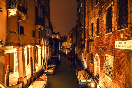 VENICE, ITALY - AUGUST 21, 2016: Famous architectural monuments, ancient streets and facades of old medieval buildings at night time close-up on August 21, 2016 in Venice, Italy.のeditorial素材