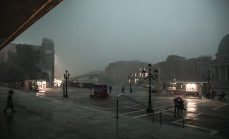 VENICE, ITALY - AUGUST 19, 2016: Colorful facades of old medieval buildings against dramatic storm clouds a day before occurred earthquakes in the country on August 19, 2016 in Venice, Italy.のeditorial素材