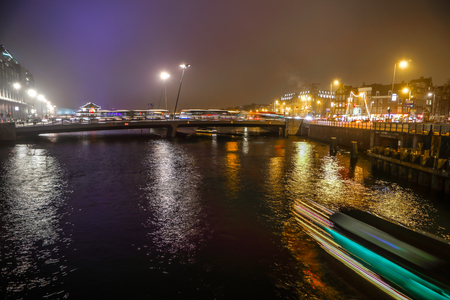 AMSTERDAM, NETHERLANDS - JANUARY 02, 2017: Cruise boat in night canals of Amsterdam. January 02, 2017 in Amsterdam - Netherland.のeditorial素材