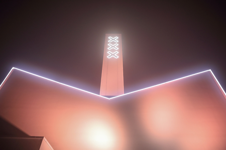 AMSTERDAM, NETHERLANDS - DECEMBER 31, 2016: Amsterdam city flag on building construction against beautiful night foggy sky on December 31, 2016 in Amsterdam - Netherland.のeditorial素材