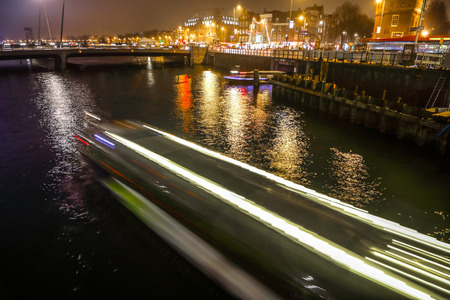 AMSTERDAM, NETHERLANDS - JANUARY 02, 2017: Cruise boat in night canals of Amsterdam. January 02, 2017 in Amsterdam - Netherland.のeditorial素材