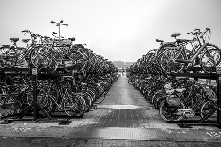 AMSTERDAM, NETHERLANDS - JANUARY 04, 2017: Two-level parking of bicycles in Amsterdam city. Amsterdam - Netherlands.のeditorial素材