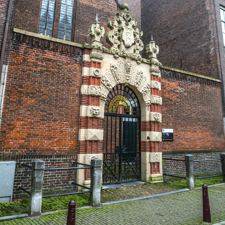 AMSTERDAM, NETHERLANDS - DECEMBER 28, 2016: Famous buildings and place of Amsterdam city centre at sun set time. General landscape view. December 28, 2016 - Amsterdam - Netherlands.のeditorial素材