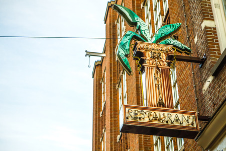 AMSTERDAM, NETHERLANDS - JANUARY 17, 2017: Old funny caution sign on building wall. January 17, 2017 in Amsterdam - Netherlands.のeditorial素材