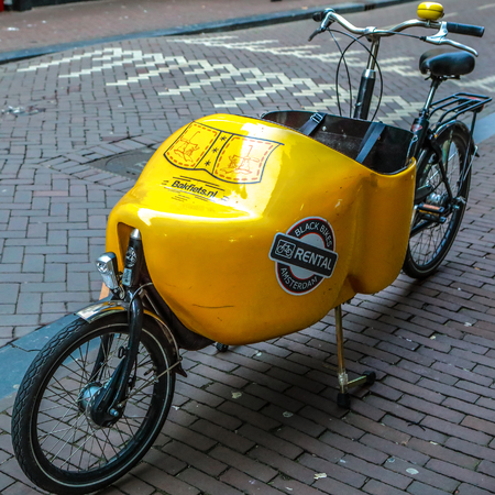 AMSTERDAM, NETHERLANDS - JANUARY 04, 2017: Parked in city street bicycle close-up. On January 04, 2017 in Amsterdam - Netherlands.のeditorial素材