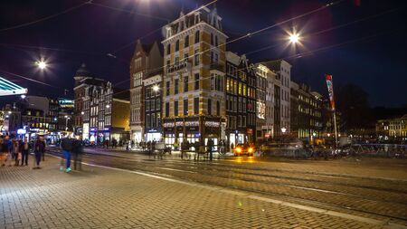 AMSTERDAM, NETHERLANDS - JANUARY 08, 2017: Night streets of Amsterdam with blurred silhouettes of passersby on January 08, 2017 in Amsterdam - Netherland.のeditorial素材