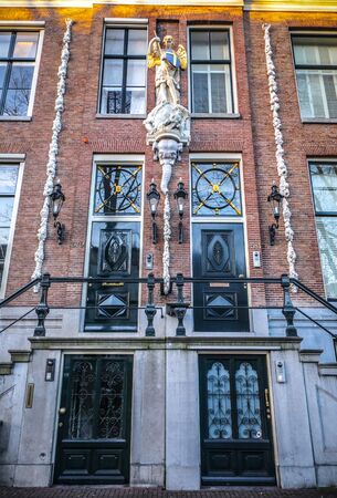 AMSTERDAM, NETHERLANDS - JANUARY 09, 2017: Famous vintage buildings of Amsterdam city at sun set. General landscape view at tradition Dutch architecture. January 09, 2017 - Amsterdam - Netherlands.のeditorial素材