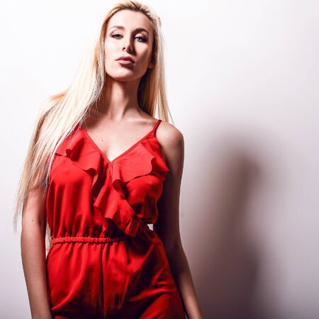 Beautiful sexy blond woman pose against studio background.の写真素材