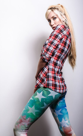 Beautiful sexy blond woman pose against studio background.の写真素材