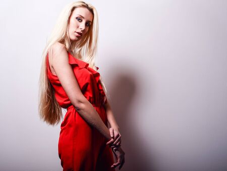 Beautiful sexy blond woman pose against studio background.の写真素材