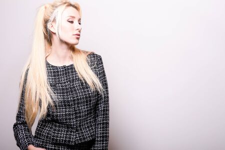 Beautiful sexy blond woman pose against studio background.
