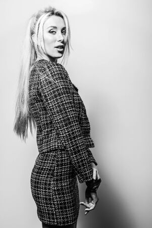 Beautiful sexy blond woman pose against studio background. Black-white photo.の写真素材