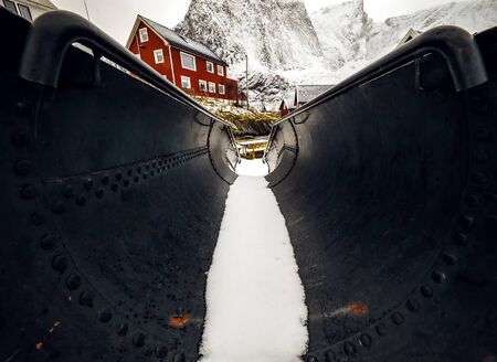Industrial black pipe with snow inside close-up.のeditorial素材