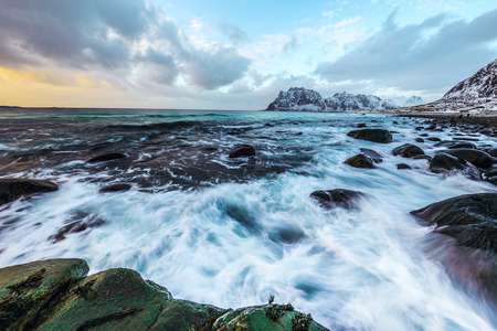 Movement of water on the shores of cold Norwegian Sea at evening time. Lofoten islands. Beautiful Norway landscape.の写真素材