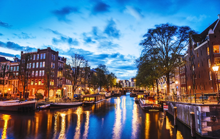 The most famous canals and embankments of Amsterdam city at night. General view of the cityscape and traditional Netherlands architecture.のeditorial素材