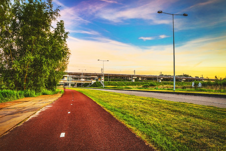 Asphalt road outside the city at twilight time.