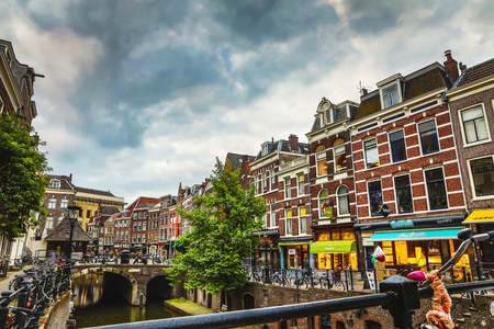 The most famous canals and embankments of Utrecht city during sunset. General view of the cityscape and traditional Netherlands architecture.のeditorial素材