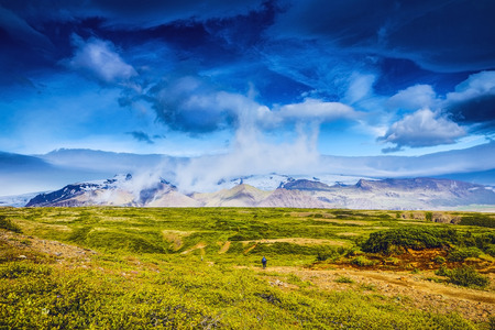 Traveler against  picturesque Icelandic landscape.の写真素材